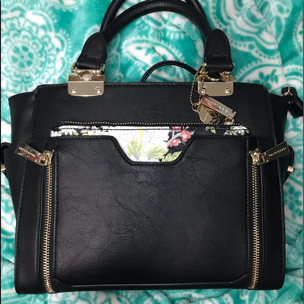 A black purse with a removable clutch on the front, plain on the back